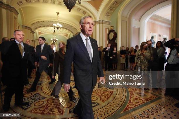 Senate Majority Leader Sen. Harry Reid walks to address the media after voting on the debt limit bill with U.S. Sen. Richard Durbin and U.S. Sen....