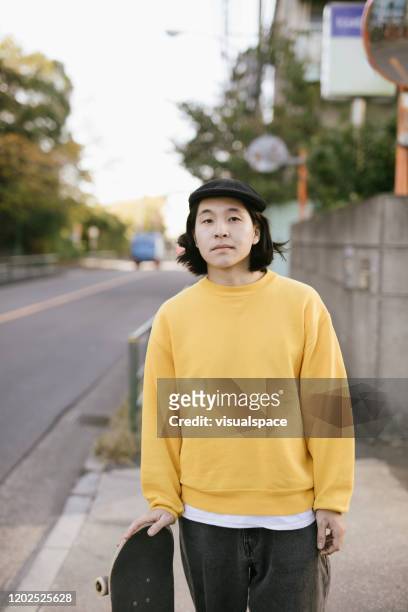 portrait of asian skateboarder - street style stock pictures, royalty-free photos & images