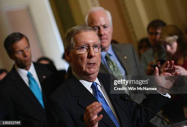 Senate Minority Leader Sen. Mitch McConnell speaks after the Senate voted on the debt limit bill as Sen. John Cornyn and Sen. John Thune look on at...