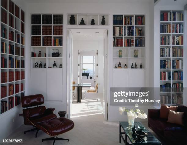 Architectural Digest, April 1997 - The library of a Chicago, Illinois apartment designed by architecture firm Tigerman McCurry, with a view to the...