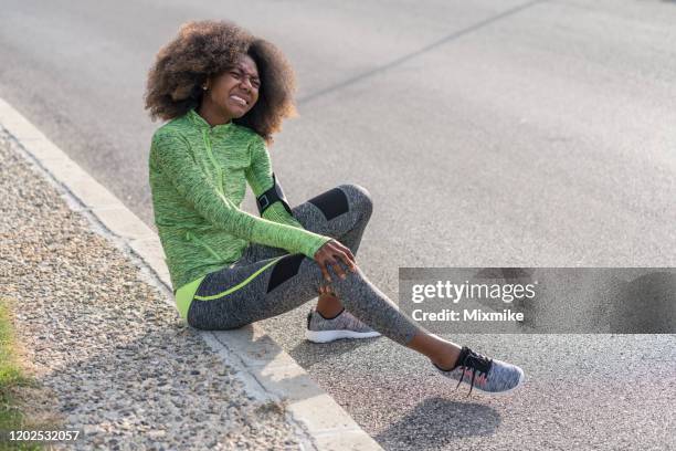 jovem mulher esportiva ferindo o joelho direito - twisted - fotografias e filmes do acervo