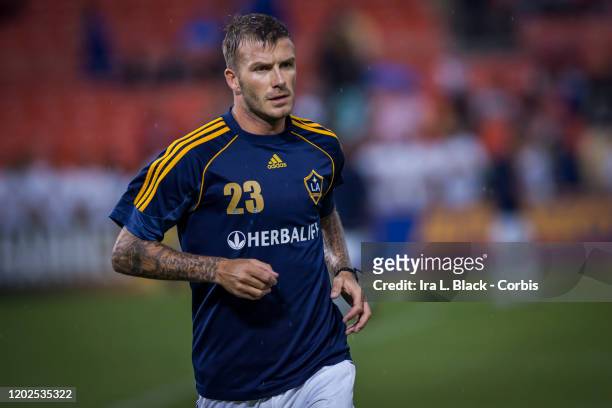 David Beckham of Los Angeles Galaxy with hair wet from the rain runs as he warms up before the Major League Soccer match between LA Galaxy and DC...