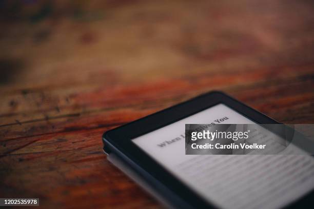 amazon kindle e-reader laying on a wooden surface - e reader stock-fotos und bilder