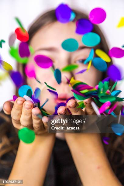 girl blowing confetti - party konfetti stockfoto's en -beelden