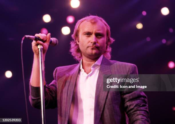 English drummer, singer, songwriter, and former member of the rock band Genesis, Phil Collins performs onstage at the Joe Louis Arena during the...
