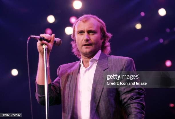 English drummer, singer, songwriter, and former member of the rock band Genesis, Phil Collins performs onstage at the Joe Louis Arena during the...