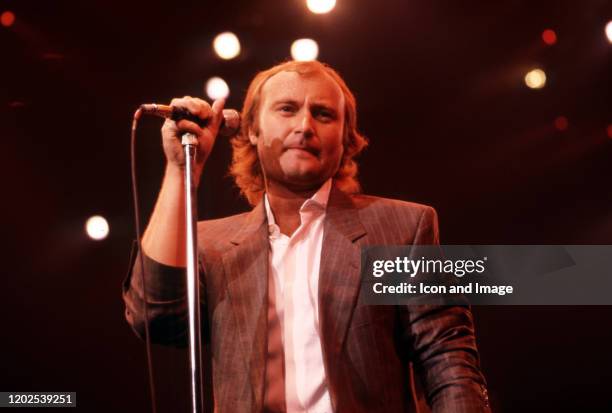English drummer, singer, songwriter, and former member of the rock band Genesis, Phil Collins performs onstage at the Joe Louis Arena during the...