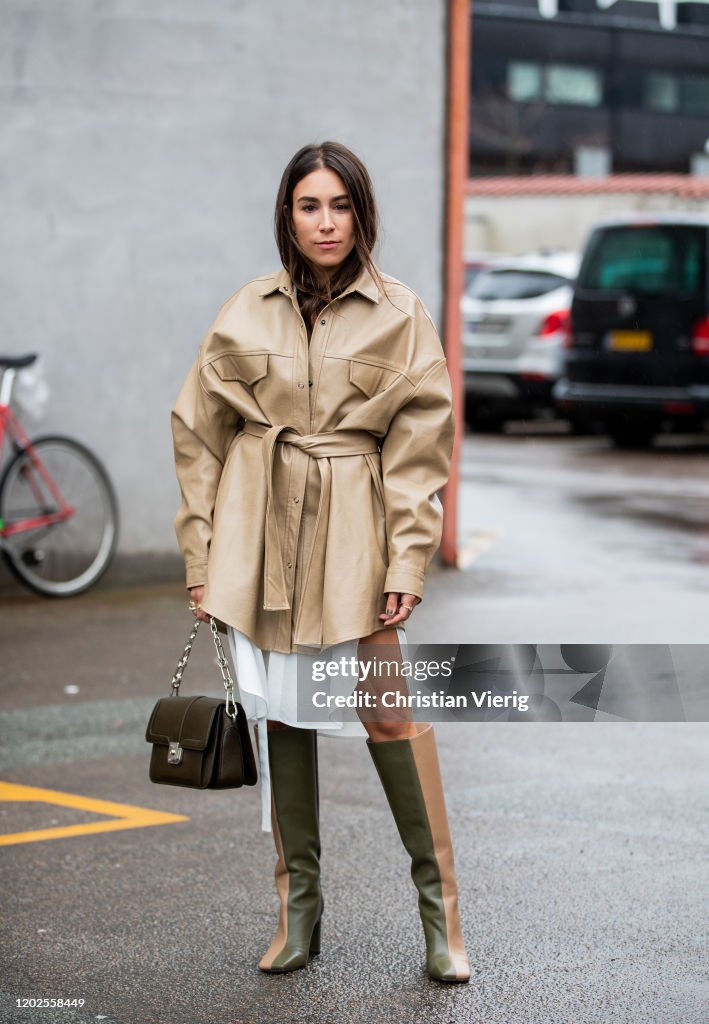Lauren Caruso wearing beige belted jacket, twon tone boot, green bag ...