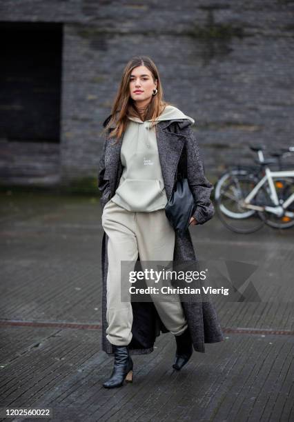Guest is seen wearing hoody, jogger pants, grey coat outside 7 Days on Day 1 during Copenhagen Fashion Week Autumn/Winter 2020 on January 28, 2020 in...