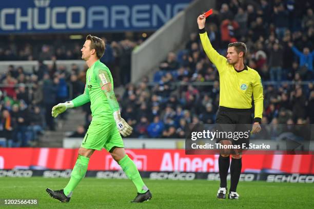 Referee Robert Kempter shows the yellow-red card to goalkeeper Manuel Riemann of Bochum during the Second Bundesliga match between DSC Arminia...