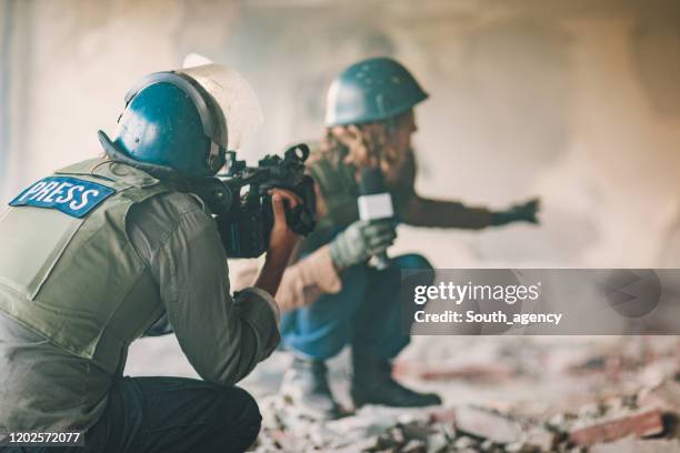 two journalists reporting from the war zone - conflict zone stock pictures, royalty-free photos & images