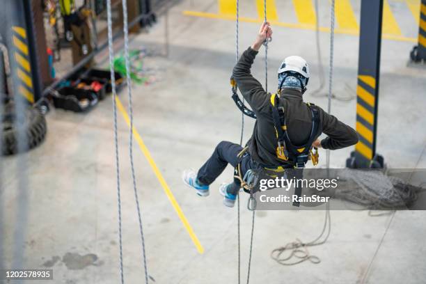 dangerous work - safety harness stock pictures, royalty-free photos & images