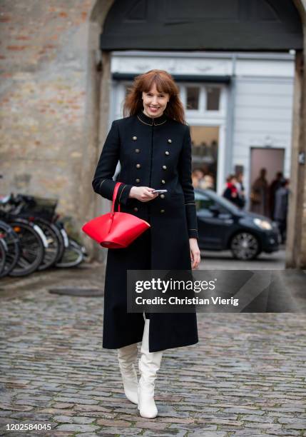 Erin Fritzpatrick seen wearing black double breasted coat, red Jil Sander bag outside Gestuz on Day 1 during Copenhagen Fashion Week Autumn/Winter...