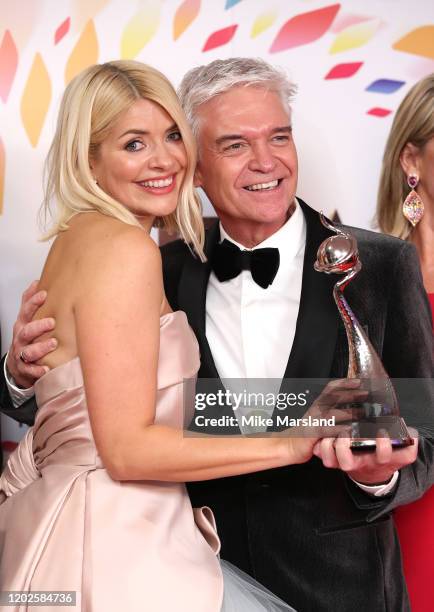 Holly Willoughby and Phillip Schofield pose with the award for Live Magazine Show for 'This Morning' in the winners room attends the National...