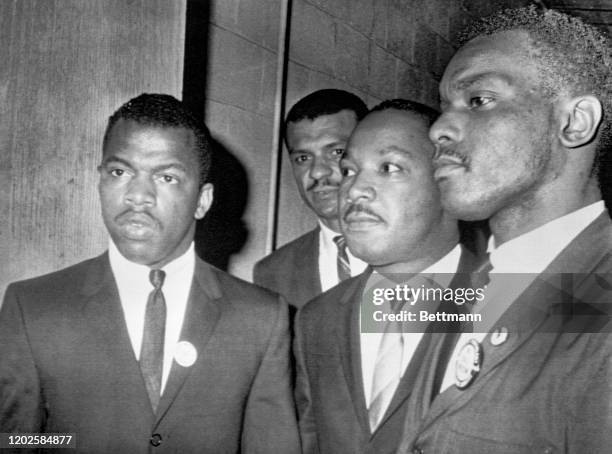 American religious and Civil Rights leader Reverend Martin Luther King Jr is escorted into a mass meeting at Fisk University, Nashville, Tennessee,...