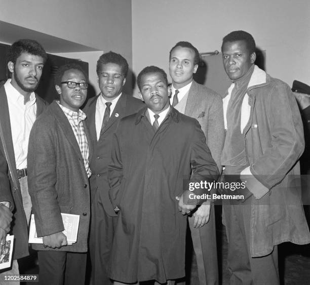 Actor Sidney Poitier and singer=actor Harry Belafonte leave Criminal Courts building after poising $50 bond each for James Forman and John Lewis....