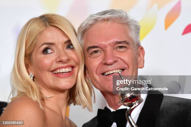 Holly Willoughby and Phillip Schofield pose with the award for Live Magazine Show for 'This Morning' in the winners room attends the National...