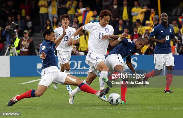 Loic Nego and Gael Kakuta from France struggles for the ball with Kim Kyung Jung from Corea del Sur during a match of Group A between Mali and Corea...