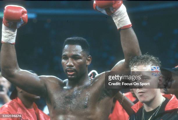 Lennox Lewis celebrates after he defeated Tyrell Biggs in a heavyweight match on November 23, 1991 at the Omni Coliseum in Atlanta, Georgia. Lewis...