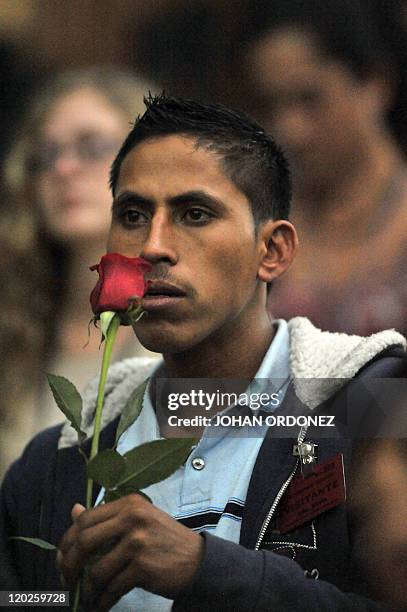 Relative of a victim of the slaugther of the villa Dos Erres holds a rose on August 2, 2011 in Guatemala City during the trial of military men...