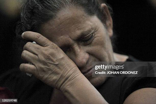 Relative of a victim of the slaugther of the villa Dos Erres wipes a tear on August 2, 2011 in Guatemala City during the trial of military men...