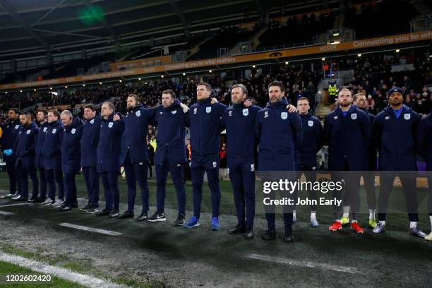 Danny Cowley Manager of Huddersfield Town stands with his coaching staff for a minute's silence in memory of Jordan Sinnott a previous Town player...