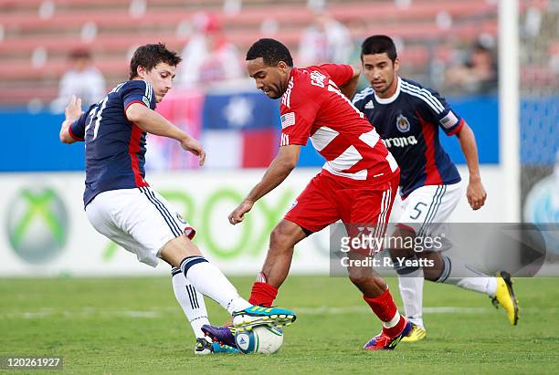 Maykel Galindo of the FC Dallas challenges Ben Zemanski of the Chivas USA for control of the ball at Pizza Hut Park on July 31, 2011 in Frisco, Texas.