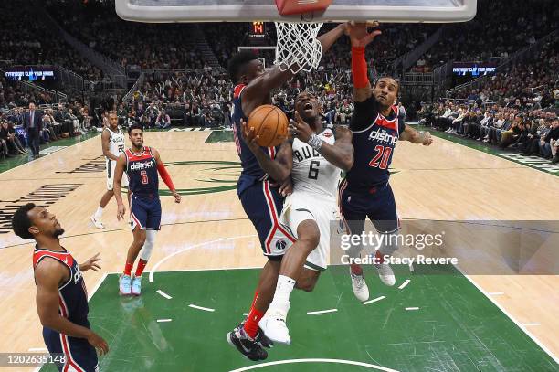 Eric Bledsoe of the Milwaukee Bucks drives to the basket against Thomas Bryant and Gary Payton II of the Washington Wizards during the second half at...