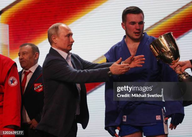 Russian President Vladimir Putin and businessman and billionaire Arkady Rotenberg during the First Combat Sambo Professional Championship on February...