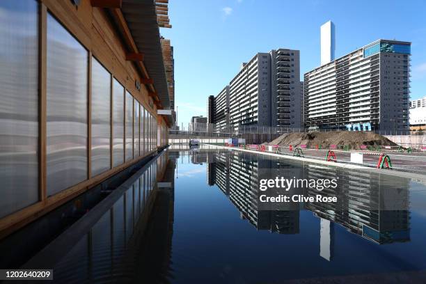 The Athletes accommodation towers are seen reflected in water outside of the Athletes' Village Plaza as it opens to media on January 29, 2020 in...