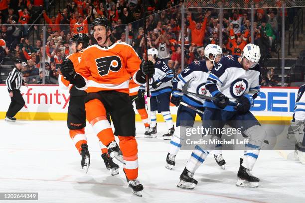 Tyler Pitlick of the Philadelphia Flyers reacts in front of Tucker Poolman of the Winnipeg Jets after scoring a goal in the third period at the Wells...