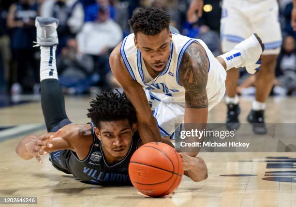 Jermaine Samuels of the Villanova Wildcats and Paul Scruggs of the Xavier Musketeers battle for the ball during the second half at Cintas Center on...