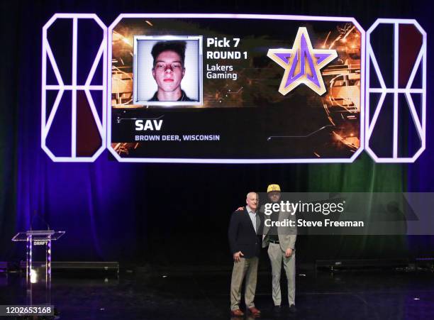 Managing Director of the NBA 2K League, Brendan Donohue poses for a photo with SAV after being drafted number seven overall by Lakers Gaming during...