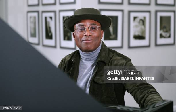 British pianist and composer Alexis Ffrench poses for a photograph after giving an interview at Steinway & Sons in London on February 19, 2020....