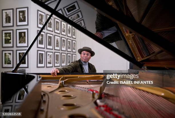 British pianist and composer Alexis Ffrench poses for a photograph after giving an interview at Steinway & Sons in London on February 19, 2020....