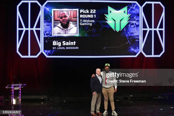 Managing Director of the NBA 2K League, Brendan Donohue poses for a photo with Big Saint after being drafted number twenty-two overall by T-Wolves...