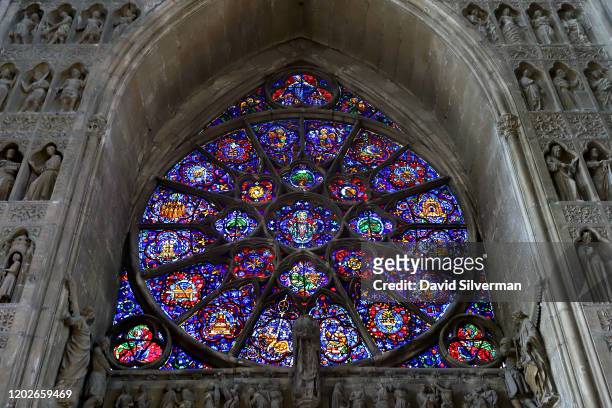 The stained-glass windows at the west end of Notre-Dame de Reims, a Roman Catholic cathedral built in the French Gothic architectural style and...