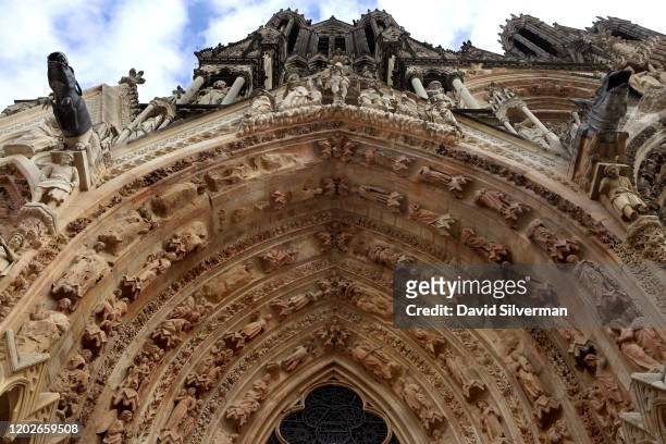 Stone carvings decorate the north doorway of Notre-Dame de Reims, a Roman Catholic cathedral built in the French Gothic architectural style and...