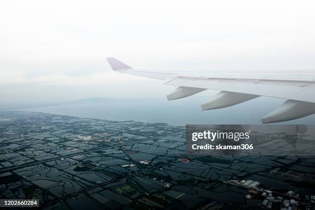 bird eye view of wing airplane fly above the cloud - broken wings stock pictures, royalty-free photos & images
