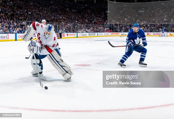 Dave Ayres of the Caroline Hurricanes plays the puck against Zach Hyman of the Toronto Maple Leafs during the second period at the Scotiabank Arena...