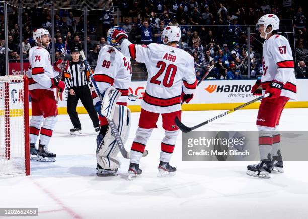 Emergency backup goaltender Dave Ayres of the Carolina Hurricanes celebrates with teammate Sebastian Aho after defeating the Toronto Maple Leafs at...