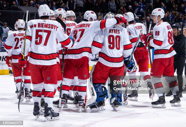 The Carolina Hurricanes celebrate with emergency backup goaltender Dave Ayres after defeating the Toronto Maple Leafs at the Scotiabank Arena on...