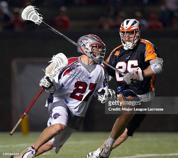 Kevin Buchanan of the Boston Cannons drives against defender Mike Timms of the Toronto Nationals on July 24, 2010 at Harvard Stadium in Boston,...