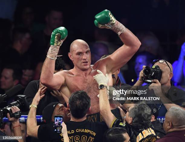 British boxer Tyson Fury celebrates after defeating US boxer Deontay Wilder in the seventh round during their World Boxing Council Heavyweight...
