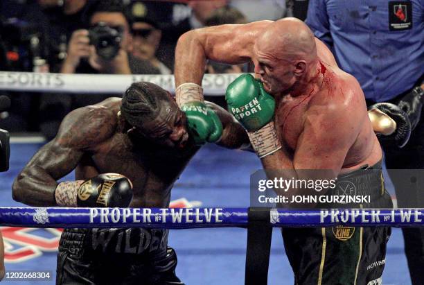 British boxer Tyson Fury slams a right to the head of US boxer Deontay Wilder during their World Boxing Council Heavyweight Championship Title boxing...