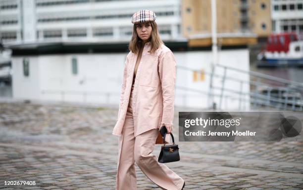 Swantje Soemmer wearing a Burberry hat and mini black leather bag before Mykke Hofmann on January 28, 2020 in Copenhagen, Denmark.