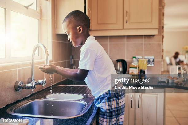 he's learnt the importance of hygiene early - child washing hands stock pictures, royalty-free photos & images