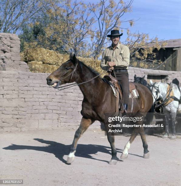 Italian-American actor Dean Martin riding a horse on the set of of the film The Sons of Katie Elder. 1966