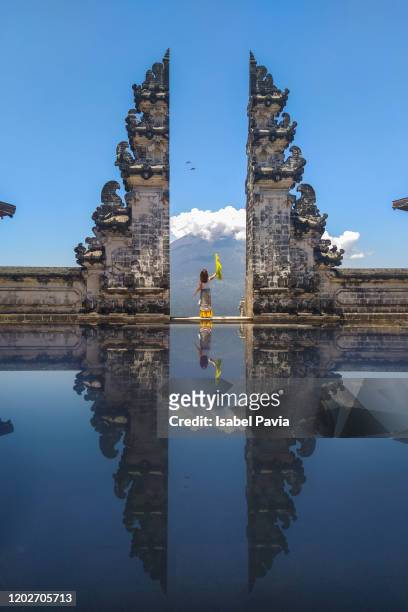 woman standing at gate to heaven of pura lempuyang temple, bali, indonesia - indonesia stock pictures, royalty-free photos & images