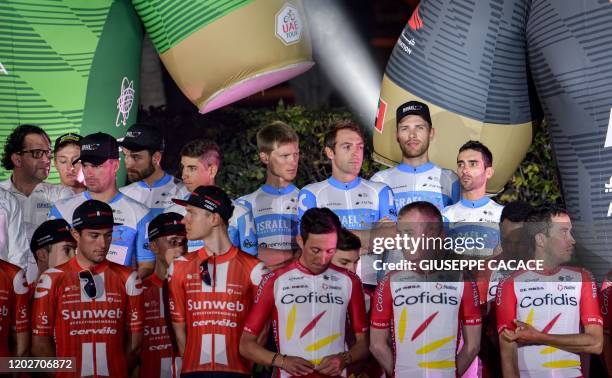 Members of Team Sunweb , Team Cofidis , and Israel Start-Up Nation team pose on the stage during the cycling teams presentation ceremony on the eve...